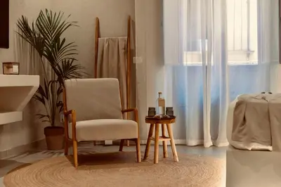 a living room with a chair and a table at Palermo Inn Collection - Boutique Art Hotel in Palermo