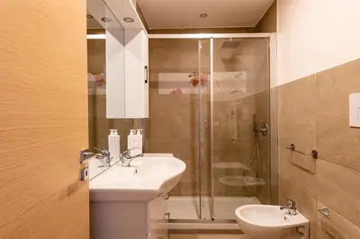 a bathroom with a sink and a shower at Kalsa Apartment with Terrace by Wonderful Italy in Palermo