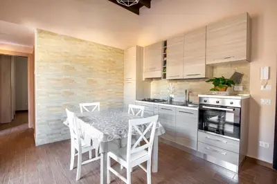 a kitchen with a table and chairs in a room at Kalsa Apartment with Terrace by Wonderful Italy in Palermo