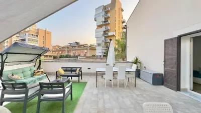 a balcony with a table and chairs and a couch at Merlo Holiday Room in Palermo