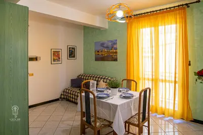 a dining room with a table and a couch at CIATU ME' Scirocco in Castellammare del Golfo