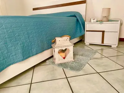 a bedroom with a bed with a box on the floor at AMATI HOLIDAYS in Palermo