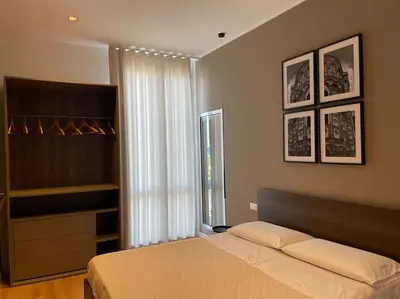 a bedroom with a large bed and a window at Nicarè City Apartments in Palermo