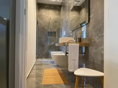 a bathroom with a sink and a toilet at Nicarè City Apartments in Palermo