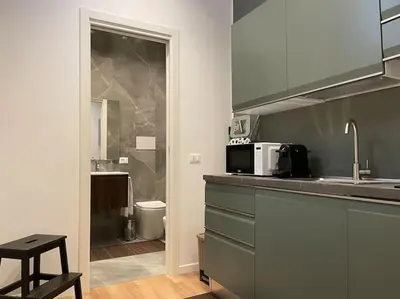 a kitchen with a counter and a sink and a microwave at Nicarè City Apartments in Palermo