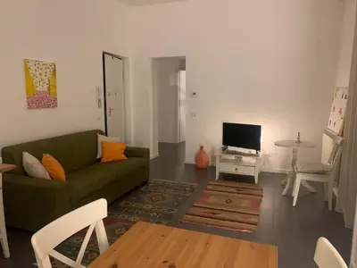a living room with a green couch and a television at La Casa di Giulia in Palermo