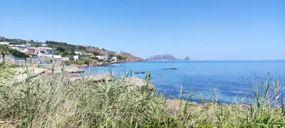 a view of a beach with houses and the water at AMUNI' Apartments in Trabia