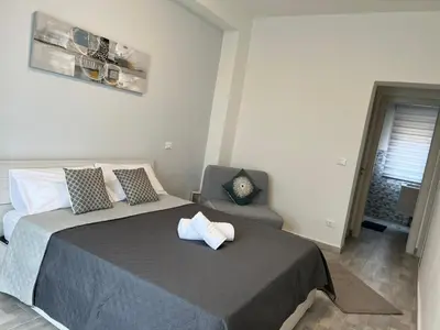 a bedroom with a bed and a chair in it at Il melograno in Carini