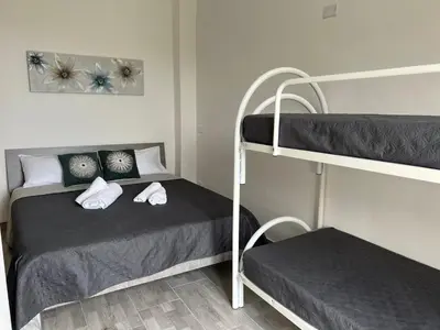a small bedroom with two bunk beds in it at Il melograno in Carini