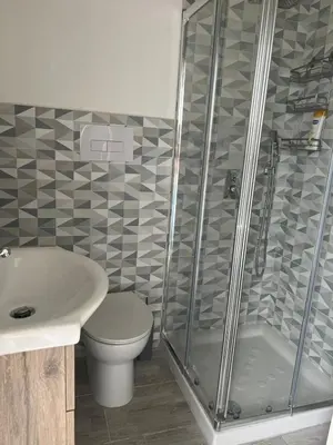 a bathroom with a shower and a toilet and a sink at Il melograno in Carini