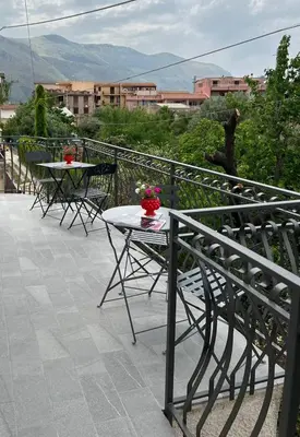 a patio with tables and chairs on a balcony at Il melograno in Carini
