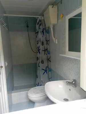 a bathroom with a sink and a toilet and a shower at Casa bluchic Gioisia in Isola delle Femmine