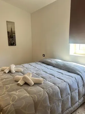 a bedroom with a large bed with towels on it at Casavacanze Alba in Alcamo