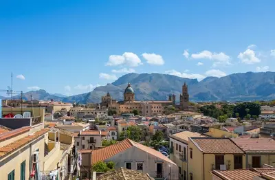 a cityscape of a city with mountains in the background at Attico nel cuore del centro storico di Palermo in Palermo