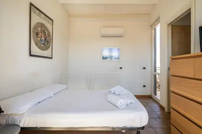 a bedroom with two beds and a tv at Attico nel cuore del centro storico di Palermo in Palermo