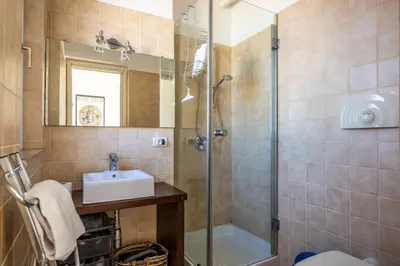 a bathroom with a shower and a sink and a mirror at Attico nel cuore del centro storico di Palermo in Palermo