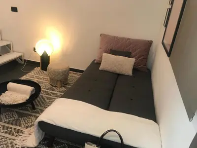 a small room with a couch and a lamp at EDU' in Alcamo
