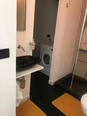 a bathroom with a sink and a washing machine at EDU' in Alcamo