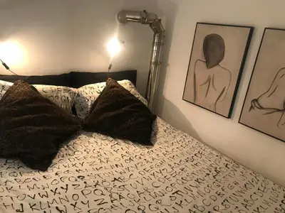 a bed with two pillows and a lamp on it at EDU' in Alcamo
