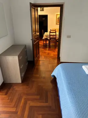 a bedroom with a bed and a wooden floor at toty alla guilla in Palermo