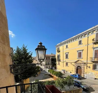 a street view of a building with a street light at toty alla guilla in Palermo