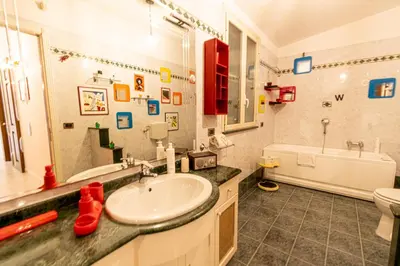 a bathroom with a sink and a toilet and a tub at Art House Arenella con Terrazze by Wonderful Italy in Palermo