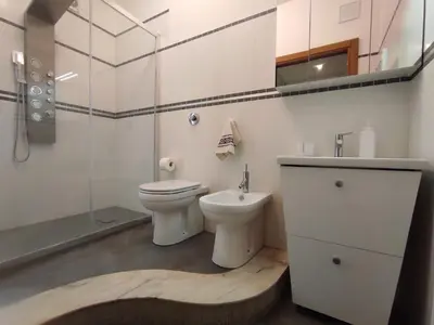 a bathroom with a toilet and a sink and a shower at Il Girasole del Centro Storico in Alcamo