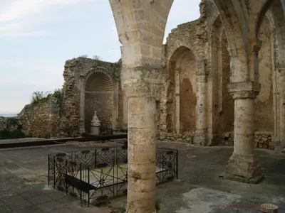 an old building with a large column in a courtyard at Il Girasole del Centro Storico in Alcamo