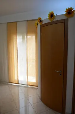 a room with a door with two flowers on the wall at Il Girasole del Centro Storico in Alcamo