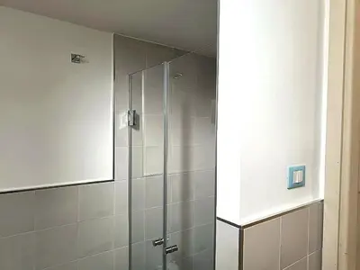 a shower with a glass door in a bathroom at Casa Cavour in Palermo