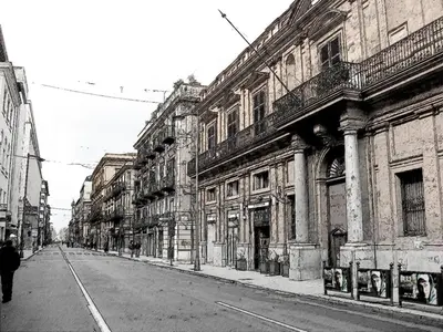a black and white photo of a street with buildings at Casa Cavour in Palermo