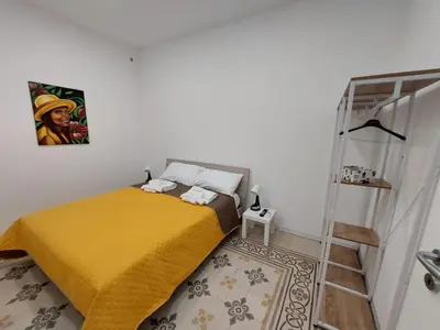 a bedroom with a bed with a yellow blanket at Al cortiletto in Castellammare del Golfo