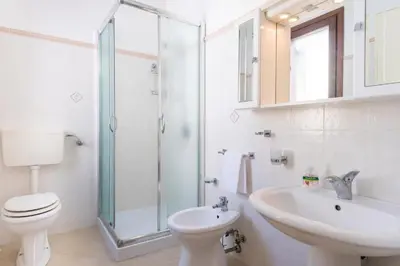 a bathroom with a toilet and a sink and a shower at Casa Vita in centro in Balestrate