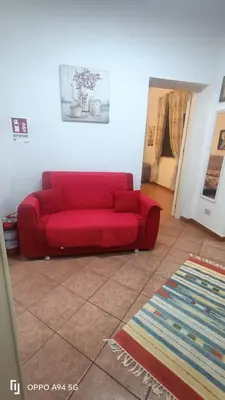 a kitchen with a table with chairs and a television at Casa Vita in centro in Balestrate