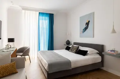 a hotel room with a bed and a chair at Hotel Principe Di Villafranca in Palermo