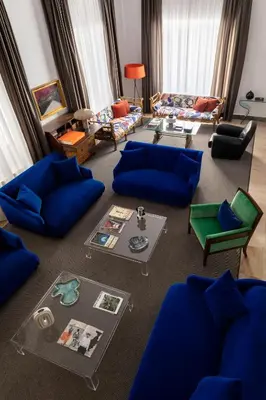 a living room with blue couches and a table at Hotel Principe Di Villafranca in Palermo
