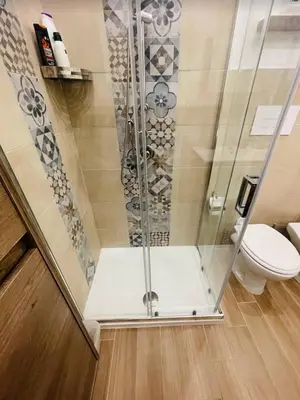 a shower stall with a toilet in a bathroom at TRISOLE Palermo in Palermo