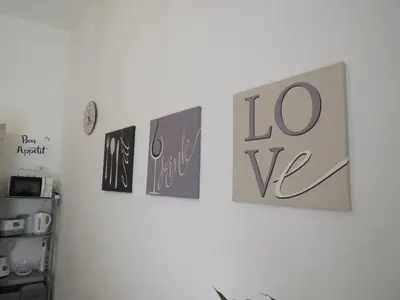 a group of pictures on a white wall at TRISOLE Palermo in Palermo