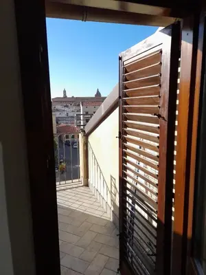 a view of a balcony from an open door at [TERRACE WITH VIEW] Attic in old town BallarHome in Palermo