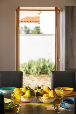 a table with bowls of lemons on top of it at Villa vista mare con piscina riscaldata a Trappeto in Balestrate