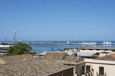 a view of a harbor with boats in the water at PalerMonAmour Art Gallery Suite in Palermo