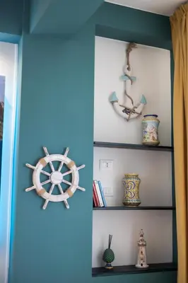 a room with a shelf with a steering wheel and vases at PalerMonAmour Art Gallery Suite in Palermo