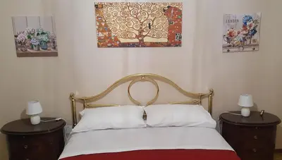 a bedroom with a bed with two night stands and two lamps at casadifederica in Palermo