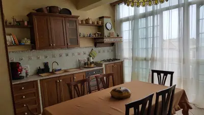a kitchen with a table and chairs and a table and a kitchen with a table at casadifederica in Palermo
