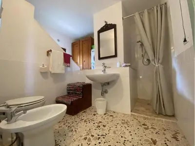 a room with two beds and a window at I Macaseni di Franca in Scopello