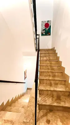 a staircase in a house with wooden floors at La casetta al mare in Palermo