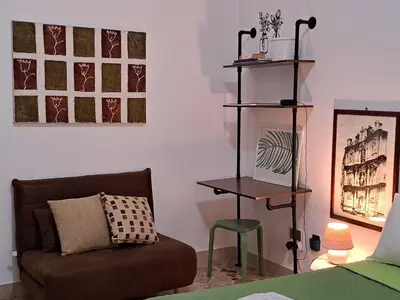 a living room with a couch and a chair at La casetta al mare in Palermo