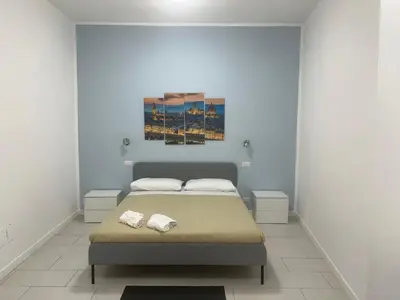 a bedroom with a bed with two towels on it at The traveler's house in Palermo