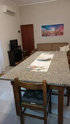 a table in a living room with a counter top at Lumera in Santa Flavia