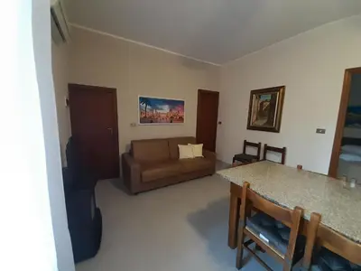a living room with a couch and a table at Lumera in Santa Flavia